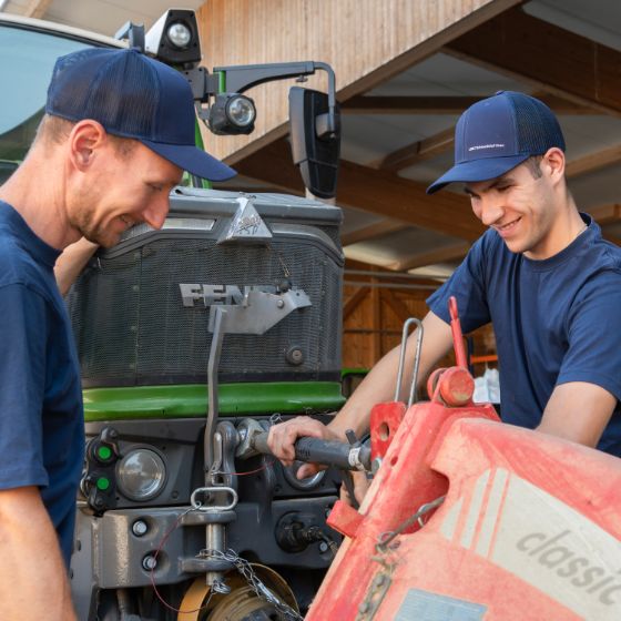 Lernender mit Berufsbildner am Traktor